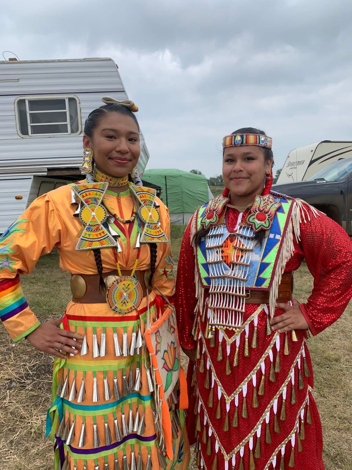 Malaysia White Eagle, 15, right, danced in the Red Dress Special Aug. 1. Her sister, PJ Halsana, 19, left, said she felt great pride watching her sister represent in this important event. (Photo credit: Jolan Kruse) 