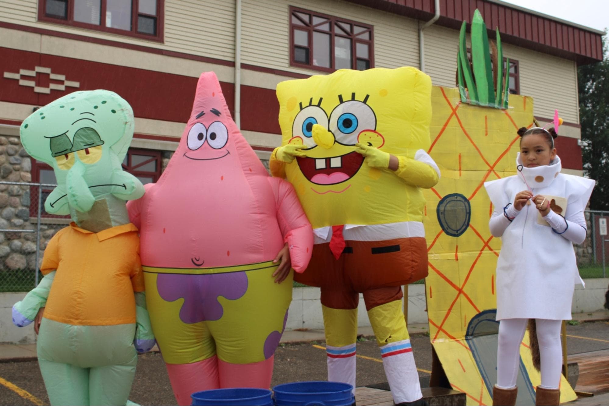 Mason Thompson as Squidward, Trevyn Thompson as Patrick Star, Aria Chase Alone as Spongebob and Ashley Chase Alone as Sandy Cheeks pose for a photo. Their SpongeBob SquarePants float went all out for the “Save Water, Save Life” theme, Saturday, Aug. 2.