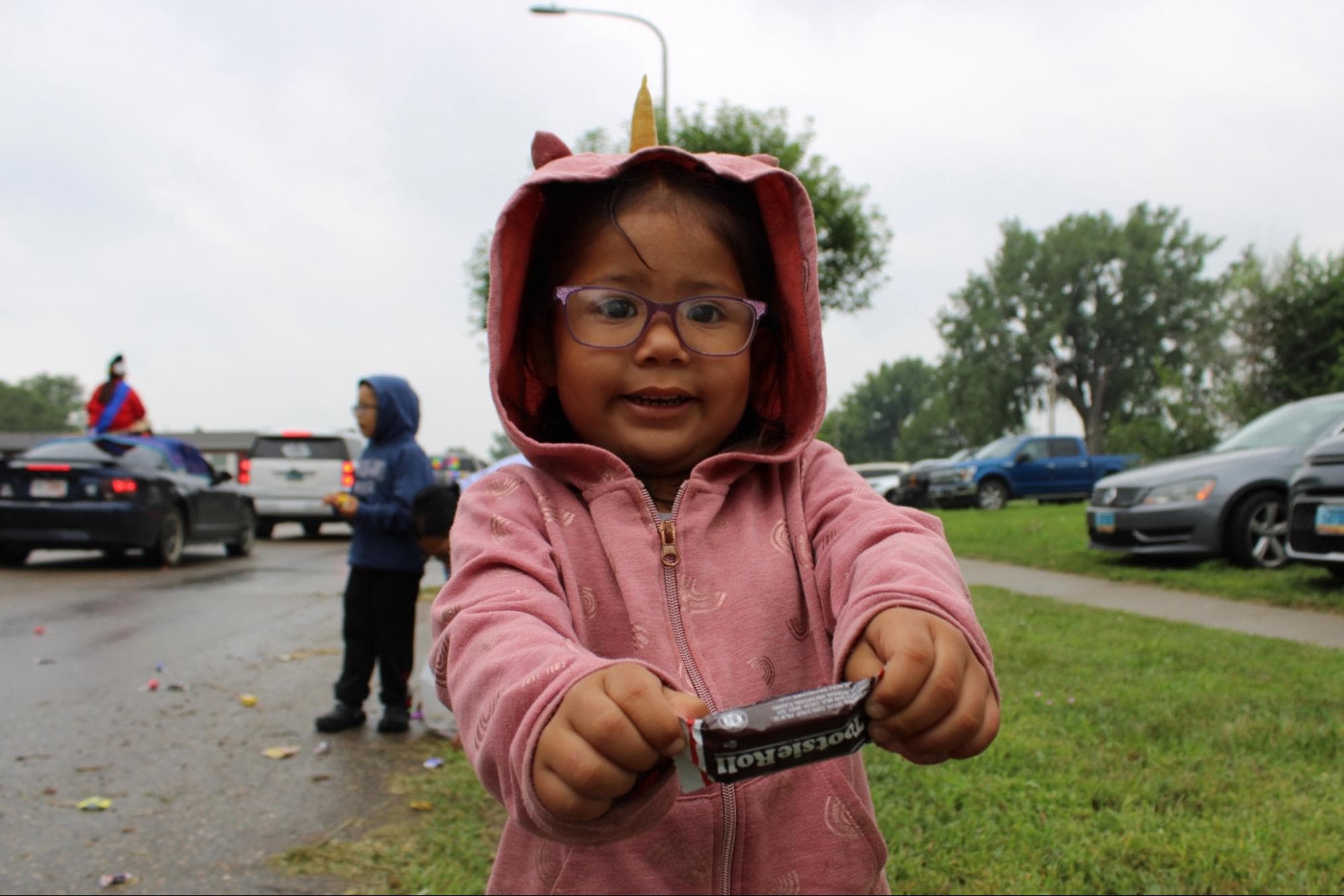 Jaylee Four Swords’s daughter presents her recently retrieved Tootsie Roll at the Long Soldier Parade, Saturday, Aug 2.