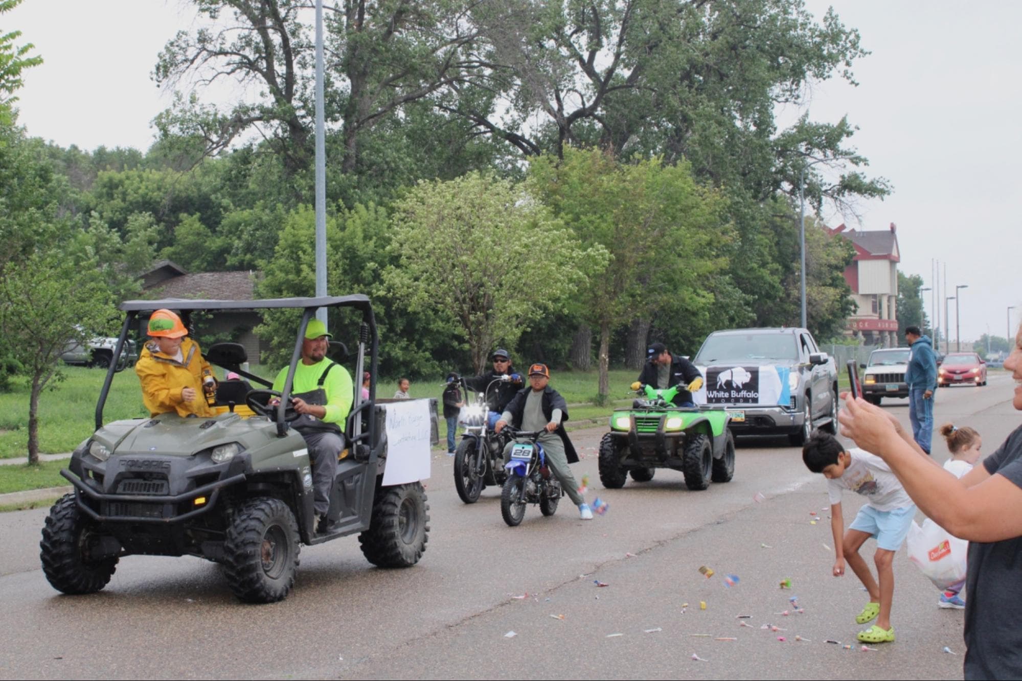 The North Range Contracting LLC and Johnson’s Wrecking throw candy to kids from their dirt bikes and four-wheelers, Saturday, Aug. 2.