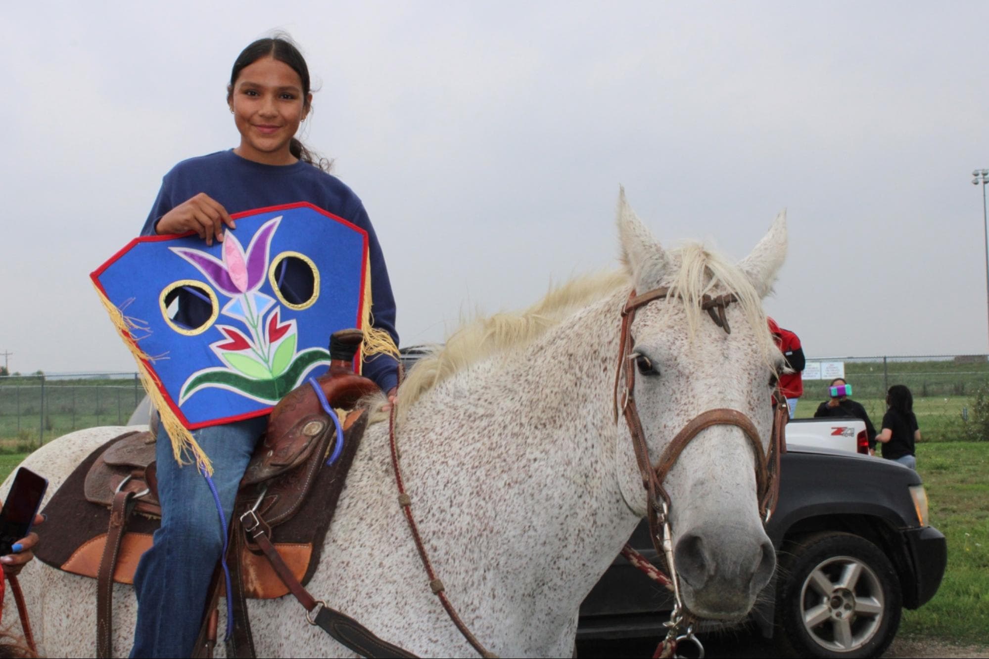 Lillian Fasthorse and her best-dressed horse, Bean, show off their prize: a handmade horse mask, August 2.
