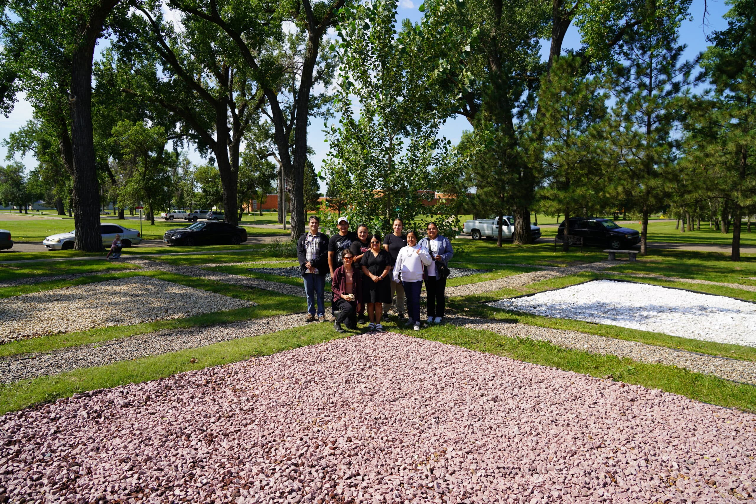 UTTC food sovereignty coordinator Sonia Ciavarelli, middle, stands with fellow faculty and UTTC students in the center of the reconstructed campus medicine wheel, Bismarck, North Dakota, Friday, Aug. 15.