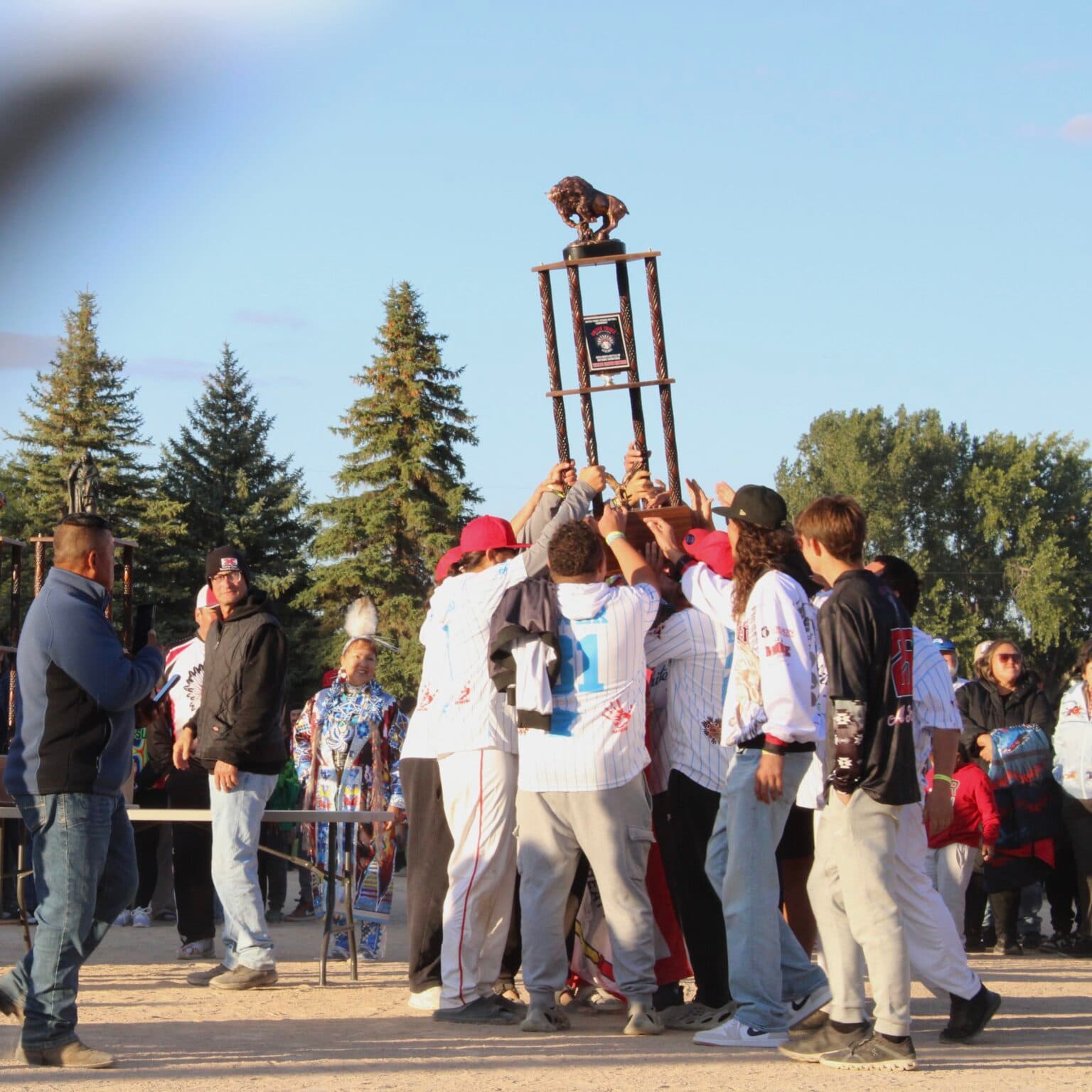 2024 Men’s Battle of Nations champions, White Earth Nation, hoist their trophy in the air. This year’s winners, Sicangu Lakota Oyate, will take home the trophy at next year’s induction ceremony, Bismarck, North Dakota, Sept. 5, 2025. (Buffalo's Fire Photo/Gabrielle Nelson)