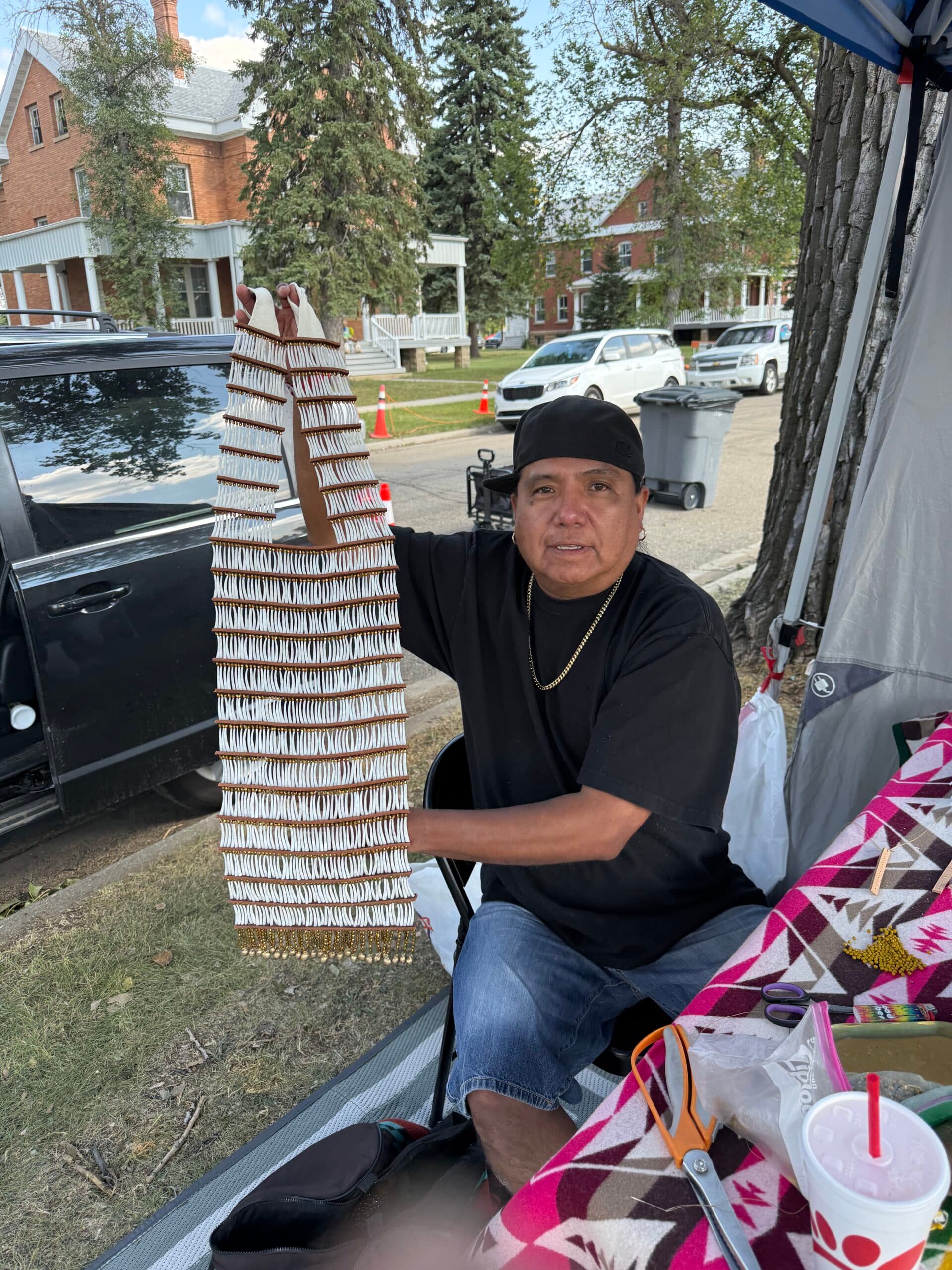 McCloud displays a finished dentalium breastplate he made during the UTTC International Powwow, Bismarck, North Dakota, Saturday, Sept. 6, 2025.
