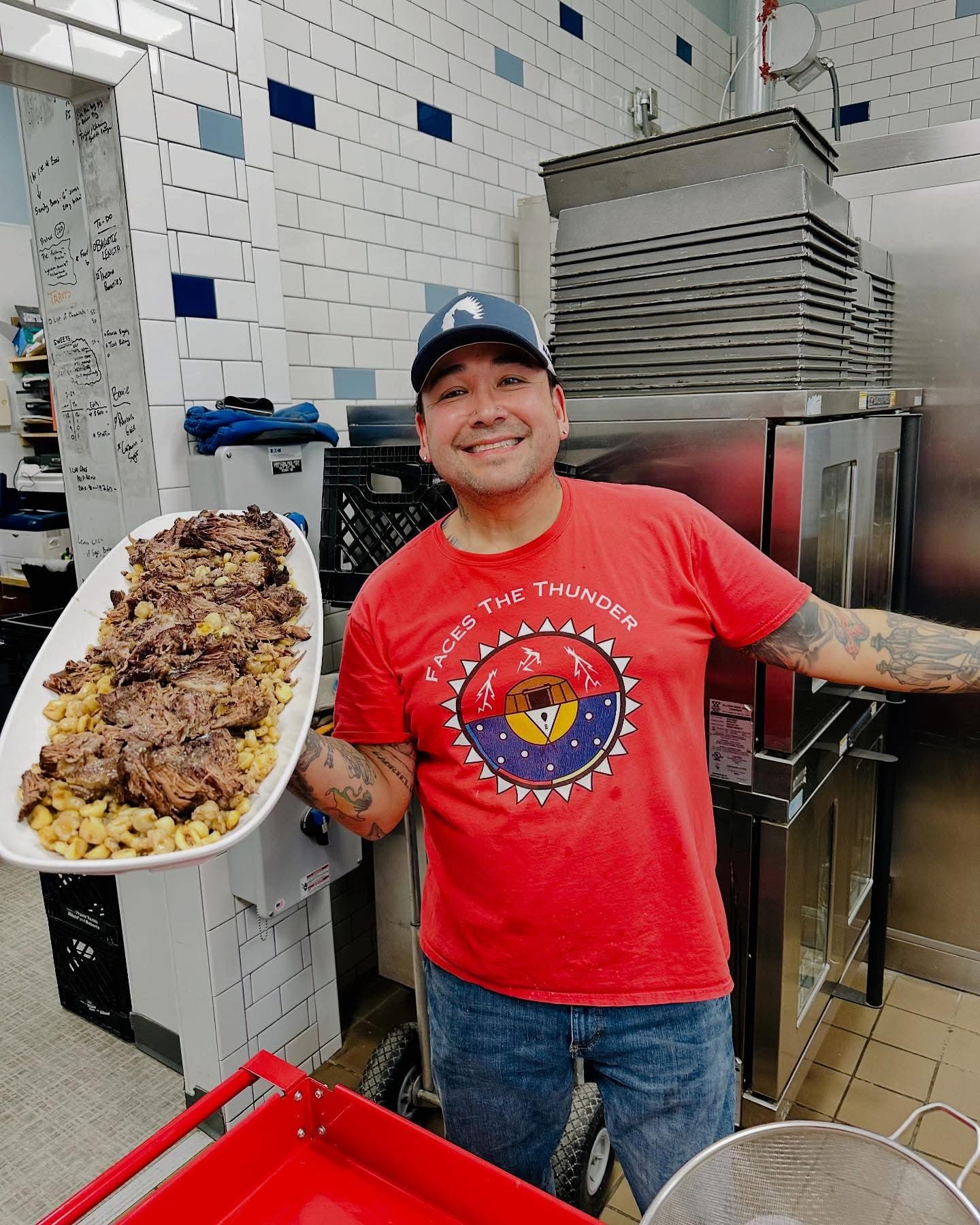 Juan De La Cruz holds a platter of braised bison and hominy he cooked and served at Aurora Nights, a culturally centered dinner event held at Prairie Sky Breads, Minot, North Dakota, Monday, April 28, 2025. (Prairie Sky Breads/Jazmine Schultz)