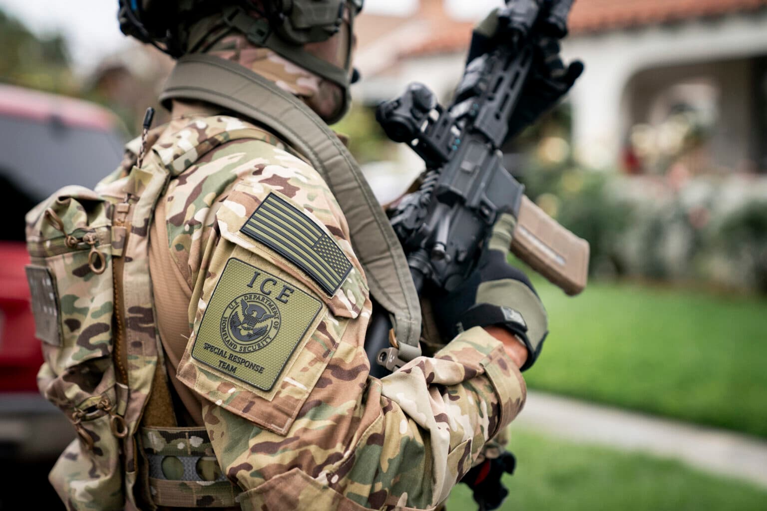 A U.S.  Immigration and Customs Enforcement (ICE) officer stands outside a Los Angeles residence as part of the agency’s enforcement and removal operations on June 12, 2025. (Department of Homeland Security/Tia Dufour) 