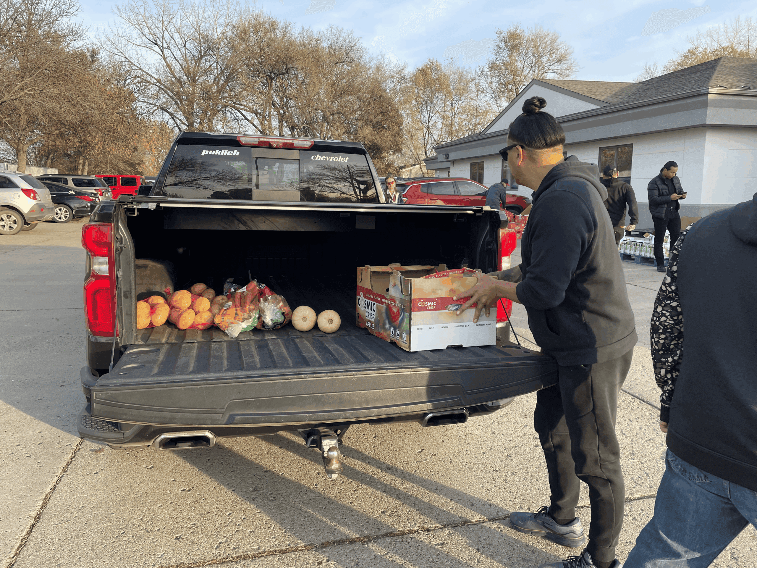 Volunteer Kory Annis, Lakota and enrolled citizen of the Cheyenne River Sioux Tribe, loads up a truck with food at Sacred Pipe Resource Center in Bismarck, North Dakota, Wednesday, Nov. 12, 2025.
