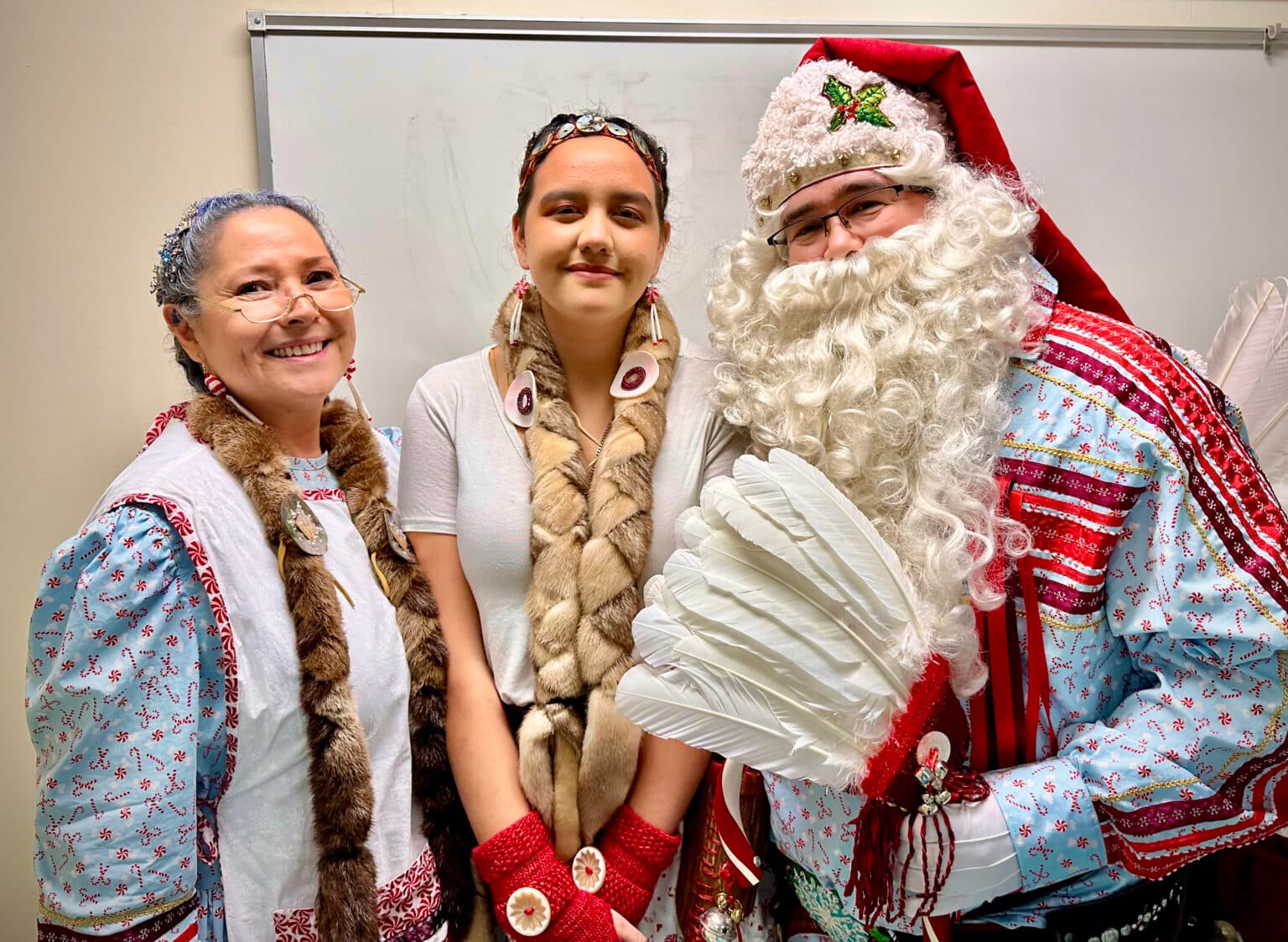 Mrs. Crystal Claus, Peppermint the Elf and Solte Santa visit the Chifin Native Youth Center in Springfield, Oregon, Sunday, Dec. 14, 2025. They are portrayed by Colleen Payne, Qalch’ema Friedlander and Jerry Payne. (Buffalo’s Fire/Brian Bull)