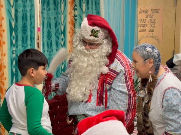 Solte Santa and Mrs. Claus talk to a boy about his wish list at the Chifin Native Youth Center in Springfield, Oregon, Sunday, Dec. 14, 2025. (Buffalo’s Fire/Brian Bull)