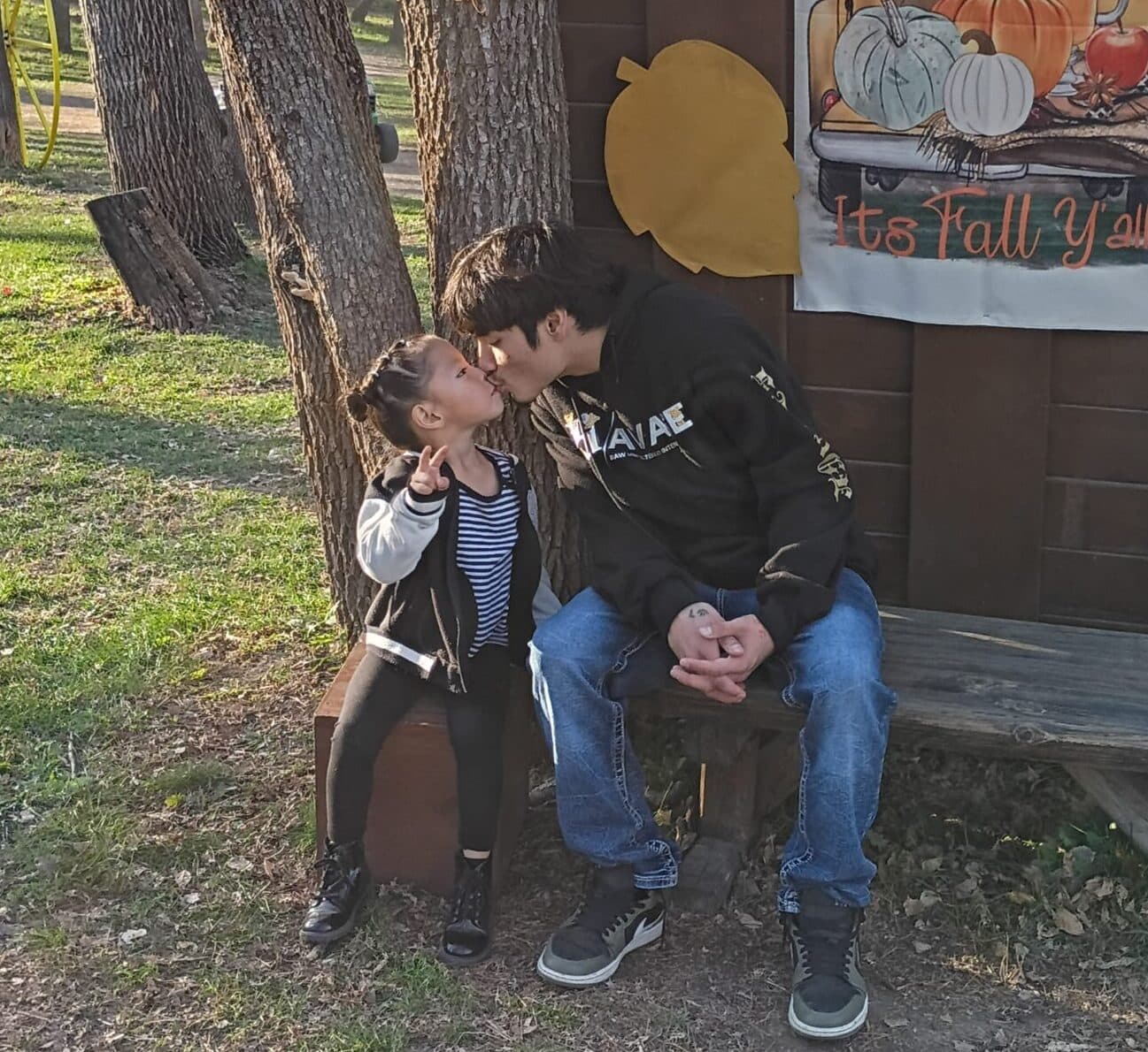 Hoksila Running Bear kisses his daughter, Arianna, at a pumpkin patch on the last day of his life, Mandan, North Dakota.
