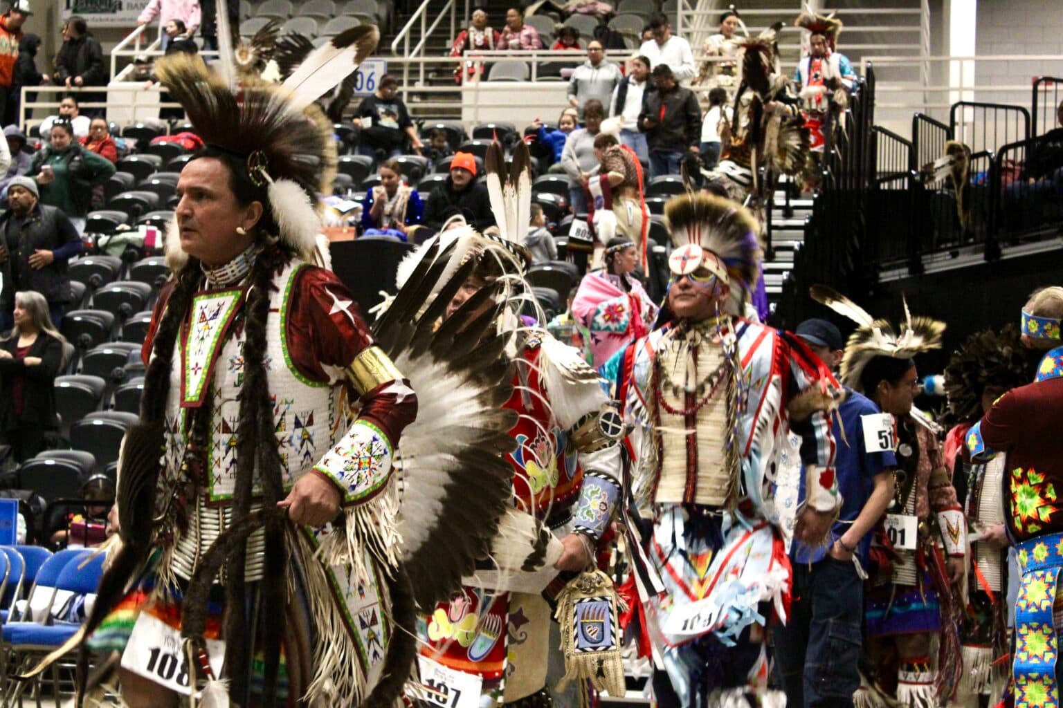 Richard Street, Crow, Sioux and Muscogee, walks into the powwow circle during the second grand entry, Bismarck Event Center, North Dakota