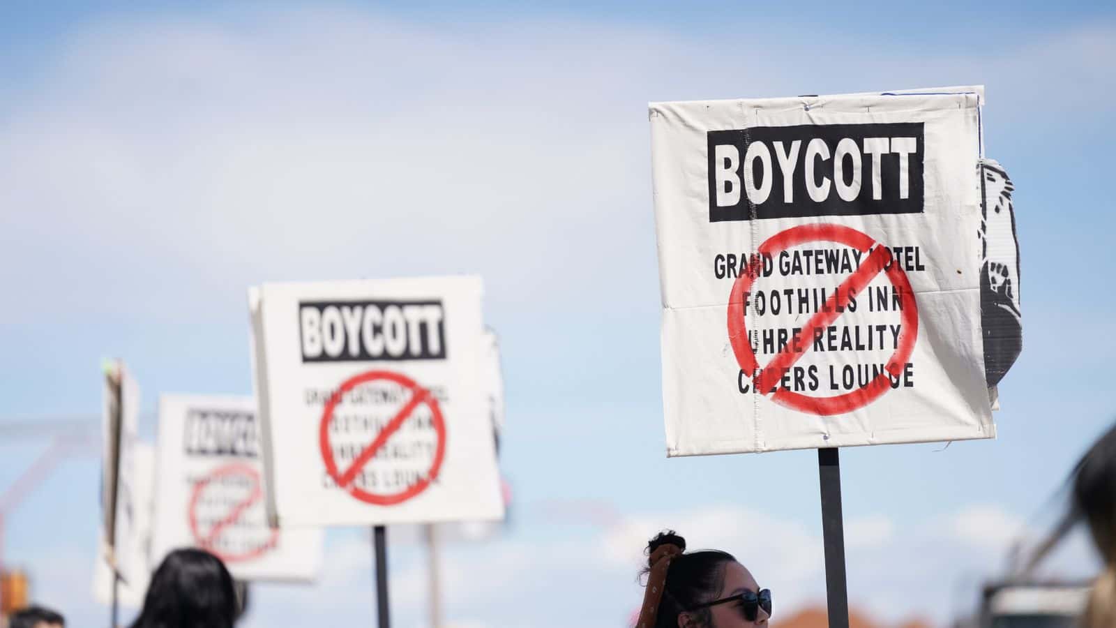Rapid City community members gather in front of the Grand Gateway Hotel forming a picket line. NDN Collective filed a civil rights lawsuit against the hotel when the owner publicly declared that they would not serve Native Americans. July 2022.