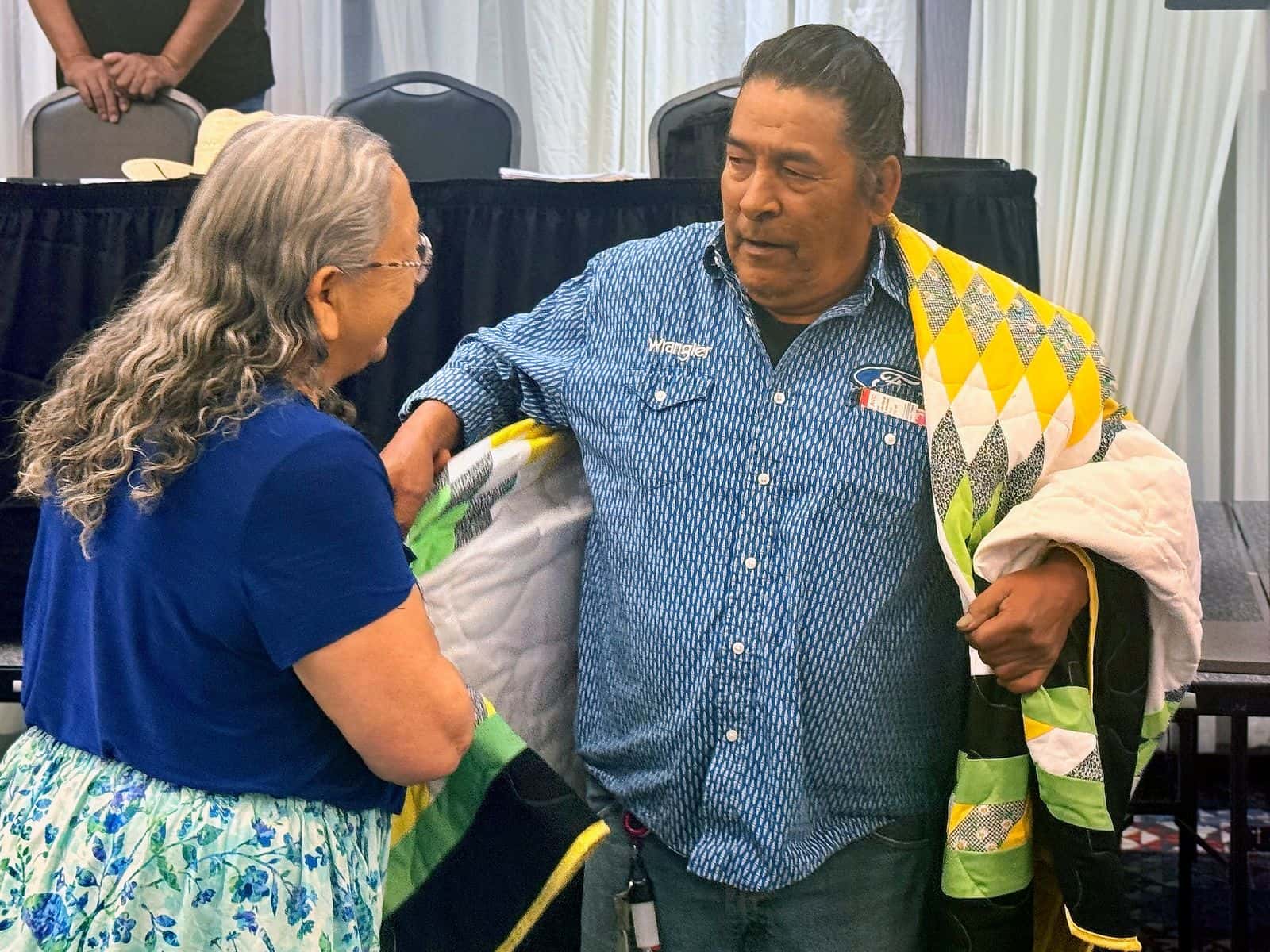 Clayton Waditaka, Wahpaton Dakota, Saskatchewan, Canada, is gifted a starquilt in recognition of his participation in the Battle of the Little Bighorn planning activities. In the mid 1800s thousands of Dakota and Lakota crossed the border to Canada to live as the buffalo herds became nearly extinct in the United States.