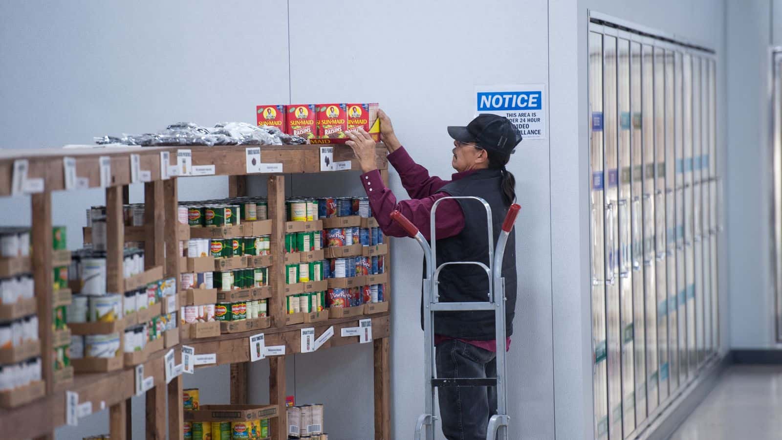 Food Distribution Program on Indian Reservations staff restocks the shelves at the Spirit Lake Food Distribution Program on the Spirit Lake Reservation in North Dakota on November 29, 2016. (USDA/Don Hamilton)