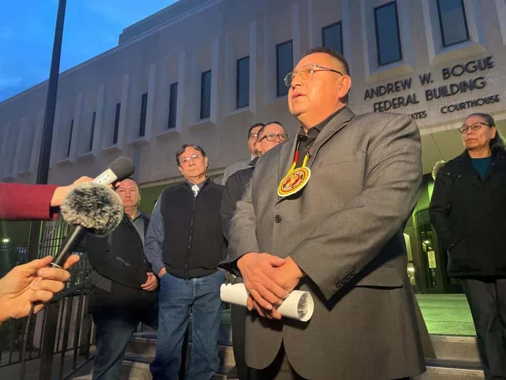 Oglala Sioux Tribe President Frank Star Comes speaks to reporters Feb. 2023 after the first day of hearings in Oglala Sioux Tribe v. United States. The tribe alleges that the United States has failed their treaty obligations by providing inadequate law enforcement funding. (Photo by Shalom Baer Gee, Rapid City Journal)