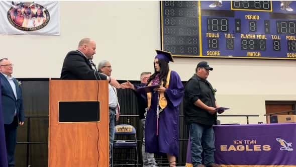 Alexandrea Brugh receives her high school diploma during New Town High School Graduation on May 26, 2024. (Photo Credit, James Brugh)