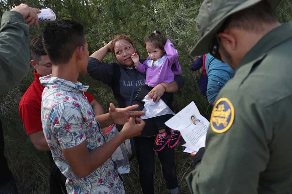 U.S. Border Patrol agents ask a group of Central American asylum seekers to remove hair bands and wedding rings before taking them into custody on June 12 near McAllen, Texas.
John Moore/Getty Images