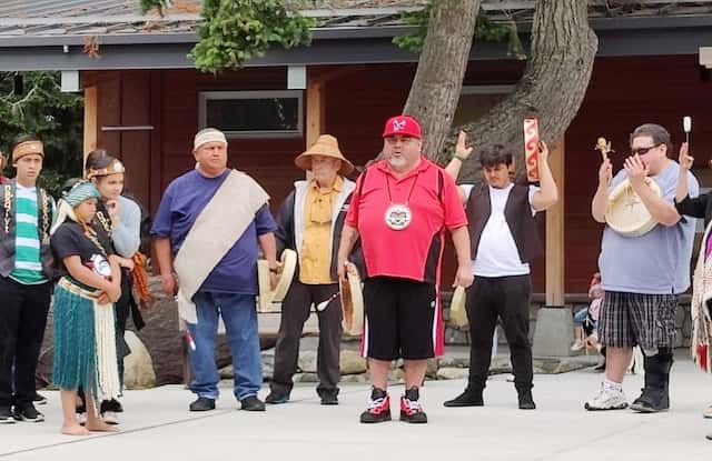 Members of the Elwha, Jamestown and Port Gamble S'Klallam tribes opened the dedication ceremony for the American Camp Visitors Center on San Juan Island in Washington State with a song on June 21, 2022. "This is who we are," said Mark Charles, in red shirt and hat at center. "We are here and we are strong." (Photo by Richard Walker for ICT)