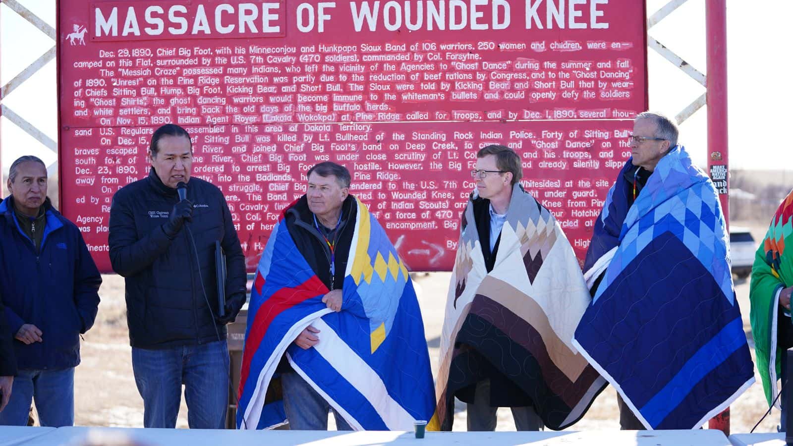 Wounded Knee descendant Michael He Crow, CRST Chairman Ryman LeBeau, Sen. Mike Rounds, Rep. Dusty Johnson and Sen. John Thune commemorate the recent signing of the Wounded Knee Sacred Site and Memorial Act, Pine Ridge Reservation, on the 135th anniversary of the Wounded Knee Massacre, Monday, Dec. 29, 2025. (Photo credit: Darren Thompson)