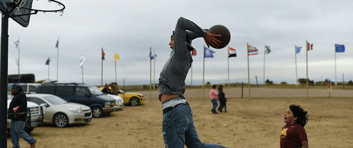 Evan Butcher of the Chippewa Tribe plays basketball near Cannon Ball, North Dakota. 2016. (Robyn Beck/AFP/Getty Images)