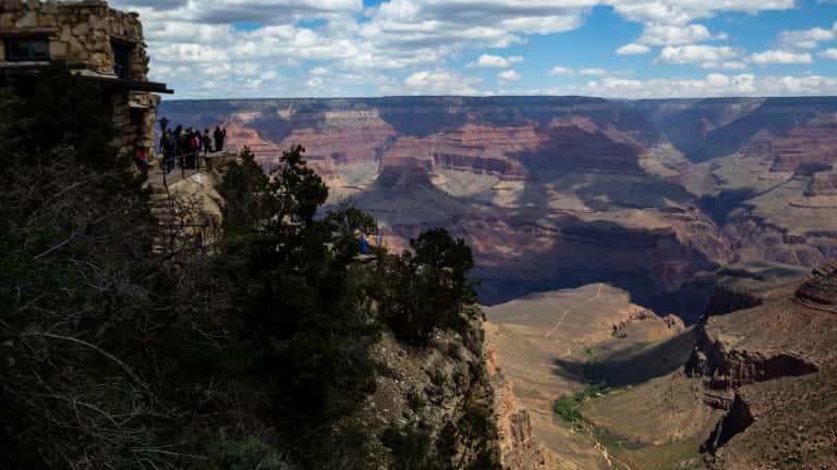Tourists look out from the South Rim at the Grand Canyon on Thursday, May 4, 2023. The Havasupai Tribe held a blessing ceremony to mark the renaming of a popular campground from Indian Garden to Havasupai Gardens. (AP Photo/Ty O'Neil)