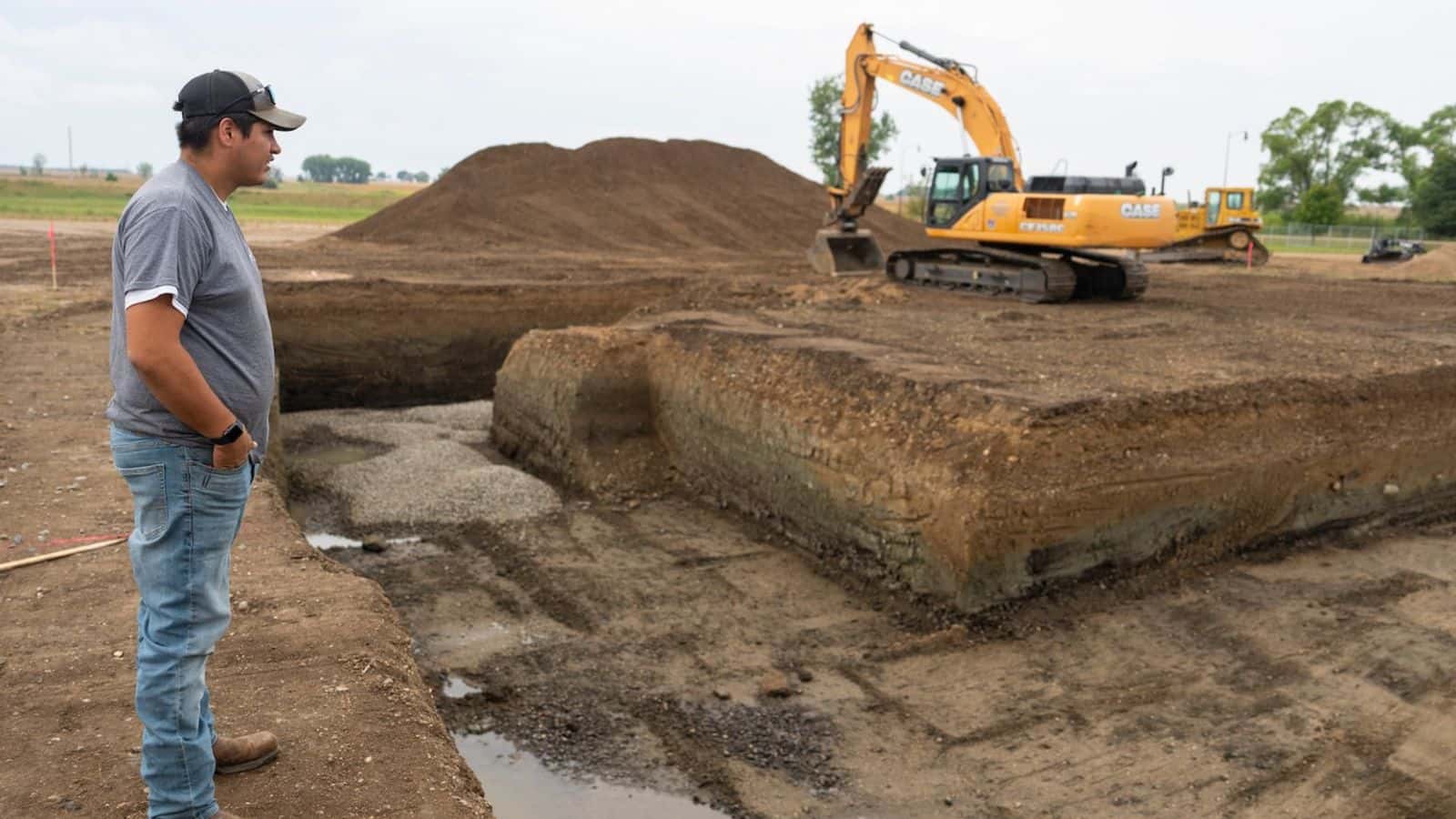 Joey Goodthunder, whose primary job is growing the Lower Sioux Indian Community’s hemp, looks over the beginnings of a foundation for a building to house the tribe’s processing equipment. (Aaron Nesheim/Grist)