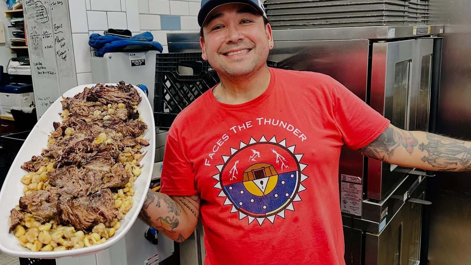 Juan De La Cruz holds a platter of braised bison and hominy he cooked and served at Aurora Nights, a culturally centered dinner event held at Prairie Sky Breads, Minot, North Dakota, Monday, April 28, 2025. (Prairie Sky Breads/Jazmine Schultz)