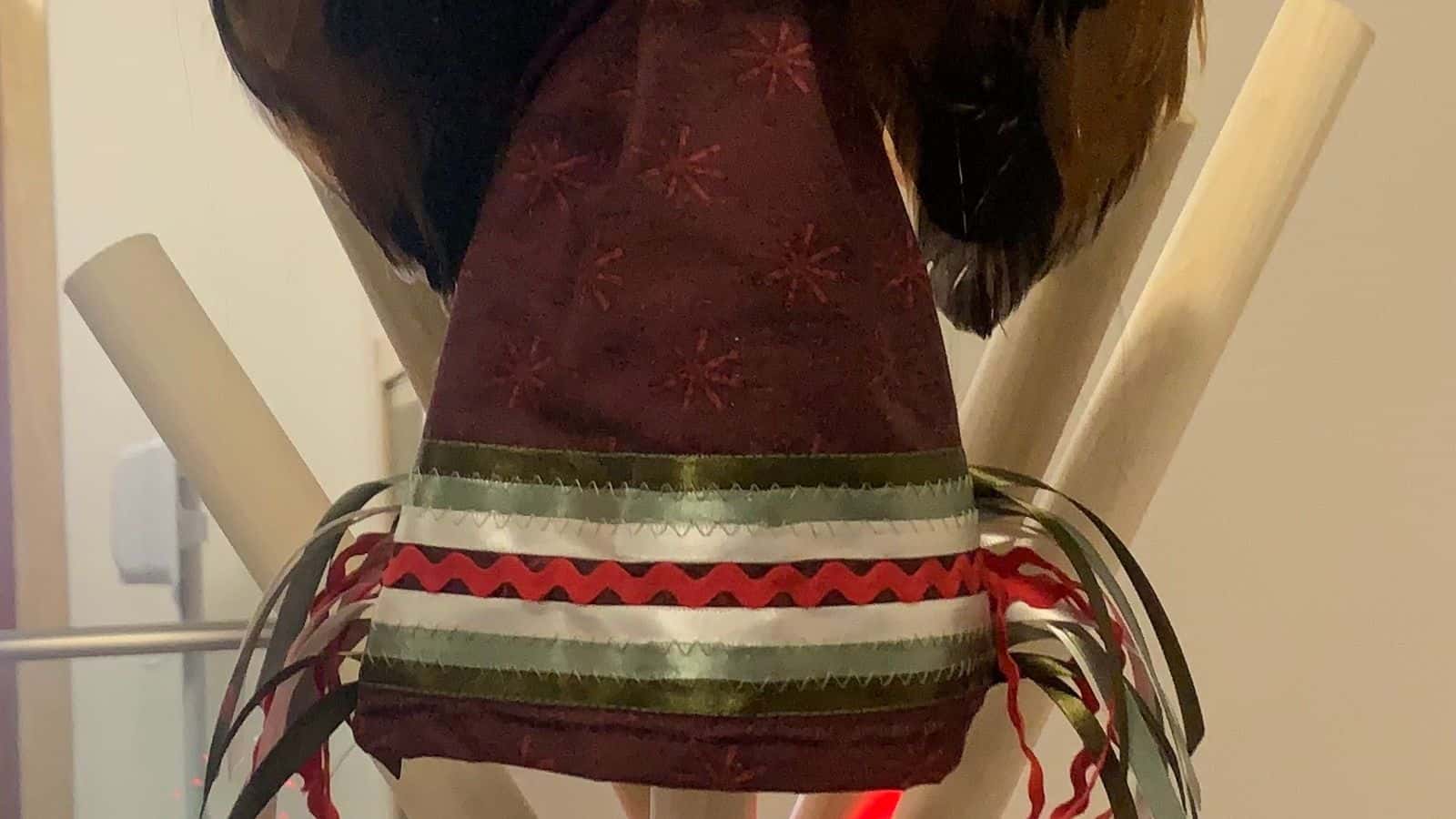 A Native angel wearing Christmas colored dentalium earrings and a ribbon skirt tops the MMIP Christmas tree, Bismarck, North Dakota, Monday, Dec. 15, 2025. (Buffalo’s Fire/Jolan Kruse)