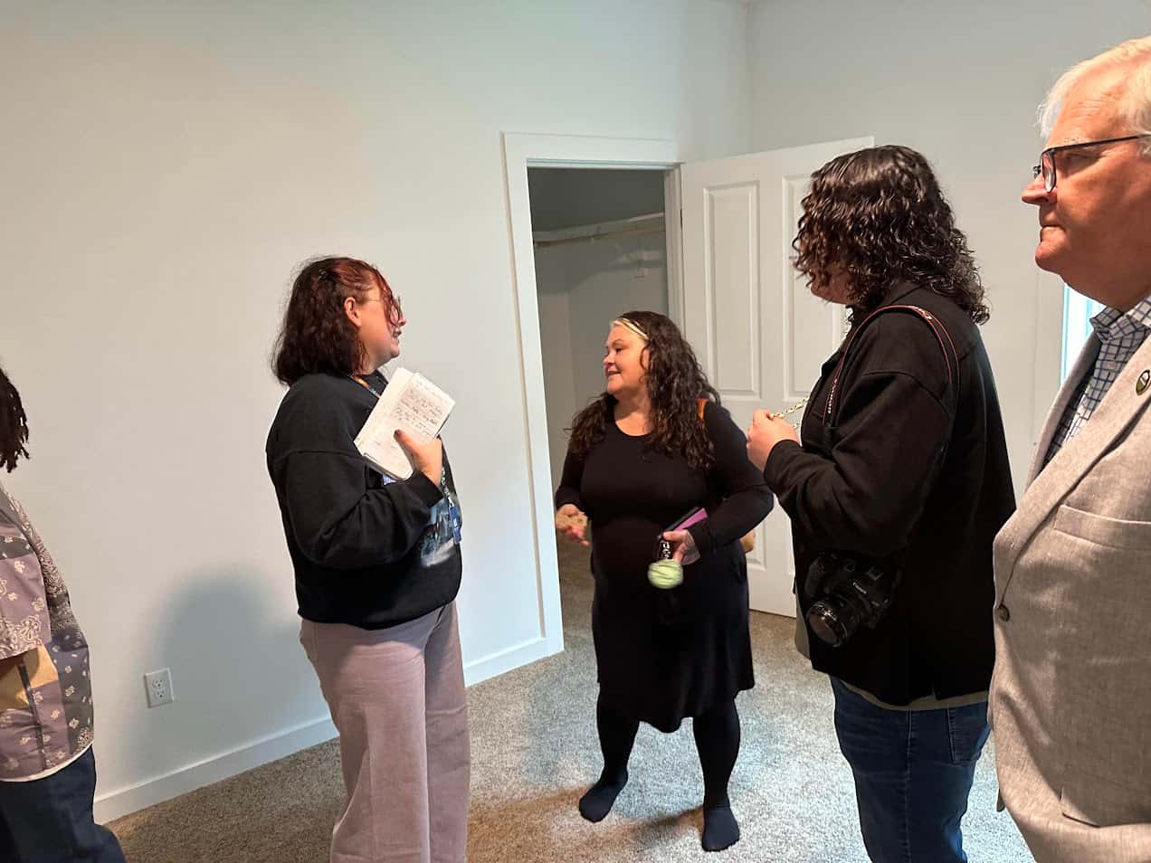 Vera Vasquez, a CTSI citizen, talks to visitors about the Kloshe Illahee Haws Housing development as they tour a two-bedroom unit, Sept. 29, 2025. Vasquez will be moving her family into a four-bedroom unit.