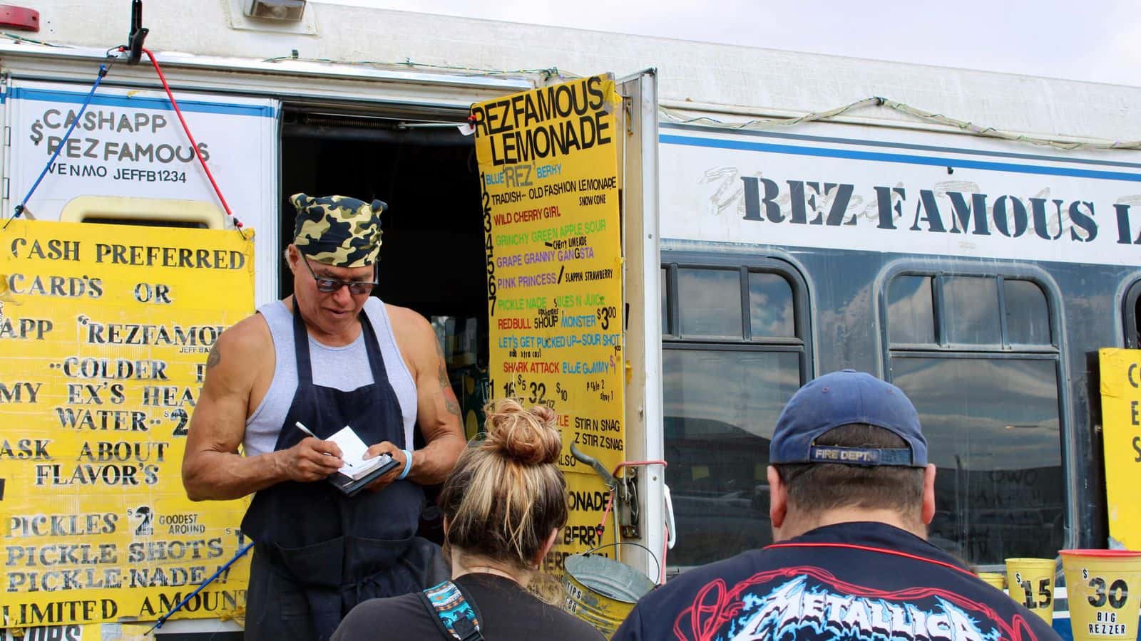 Jeff Baker, a citizen of the Turtle Mountain Band of Chippewa Indians and owner of Rez Famous Lemonades, takes a customer’s order at the UTTC International Powwow, Bismarck, North Dakota, Saturday, Sept. 6, 2025. Baker has been selling his unique lemonades at powwows for around 25 years. (Buffalo’s Fire/Gabrielle Nelson)