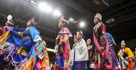 Royalty from different communities from across the nation participate in the Friday night grand entry of the 2022 Black Hills Powwow at The Monument. (Photo by Matt Gade, Rapid City Journal)