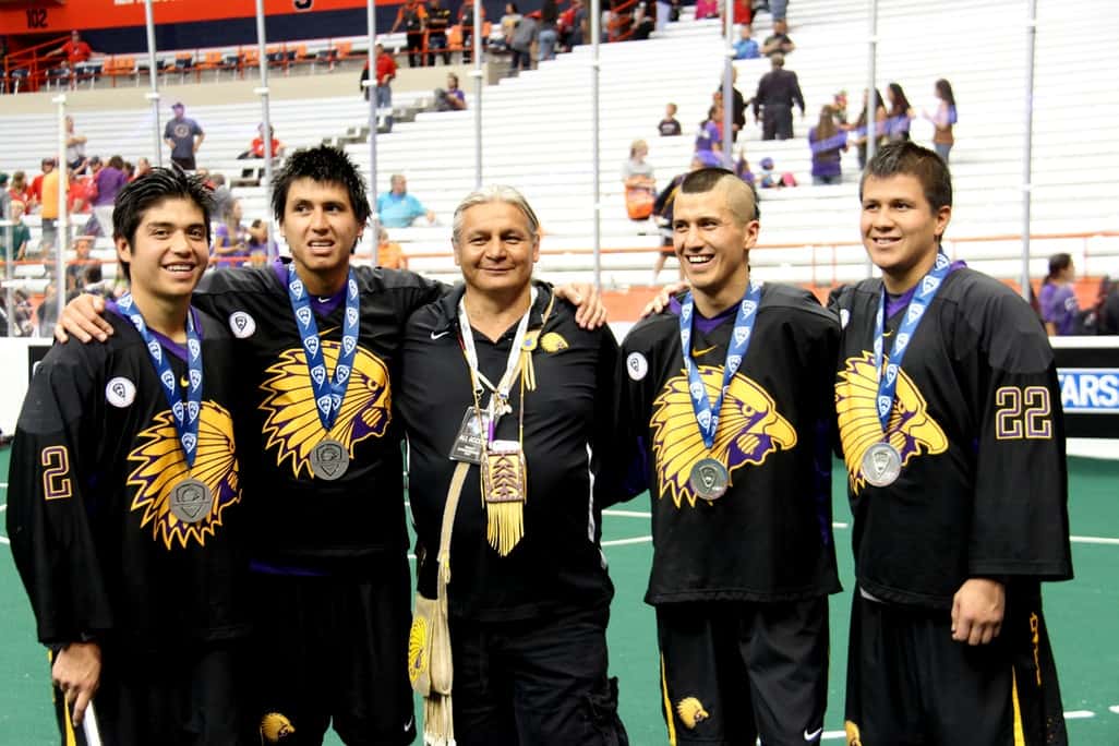 The four Thompson Brothers stand with Iroquois National host Tracy Shenandoah (center) at the Lacrosse championships in Syracuse New York in 2015. Photo Vincent Schilling
