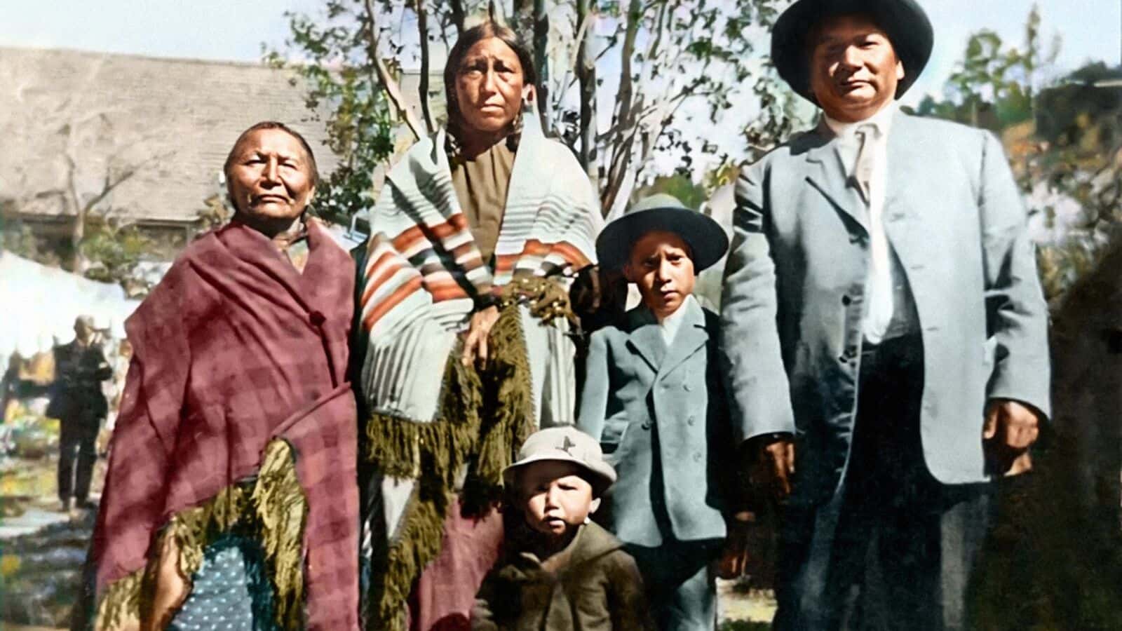 Stephan Curran colorized this 1930s photo showing the family of HAWK 1890 member Marlis Afraid of Hawk at Pine Ridge Reservation. Left to right, her great-grandmother "He Ska Win"/White Mountain Woman; grandmother Mabel Cetan Kokipa/Afraid of Hawk; grandfather Richard Cetan Kokipa/Afraid of Hawk; and their two sons, Bert and Cain Cetan Kokipa/ Afraid of Hawk. Grandfather Richard survived the massacre. (Family photo courtesy of Marlis Afraid of Hawk)