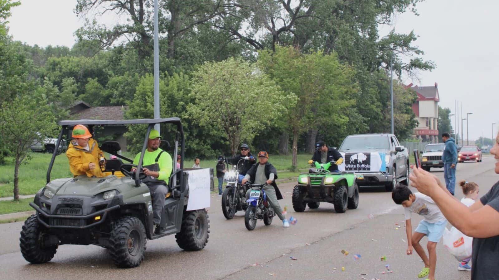 The North Range Contracting LLC and Johnson’s Wrecking throw candy to kids from their dirt bikes and four-wheelers, Saturday, Aug. 2.