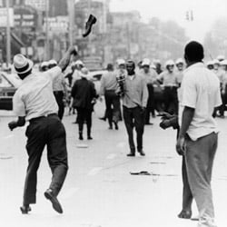 A man hurls a shoe at Detroit police on July 23, 1967. Then-Michigan Gov. George Romney was profoundly affected by the riots and worked for housing integration during both his governorship and while secretary of the Department of Housing and Urban Development in the Nixon administration. (AP Photo)