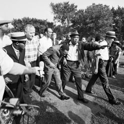 Dr. Martin Luther King Jr. ducks after being hit in the head by a rock during a housing discrimination protest in Chicago on Aug. 5, 1966. (Bettmann/Corbis/AP Images)