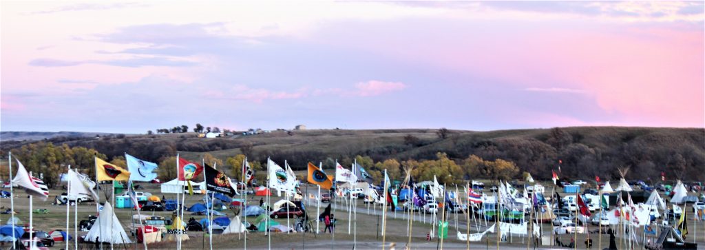 Native nations flags fly along the entrance to the Oceti Sakowin Camp to show unity among tribes in the standoff with Dakota Access Pipeline