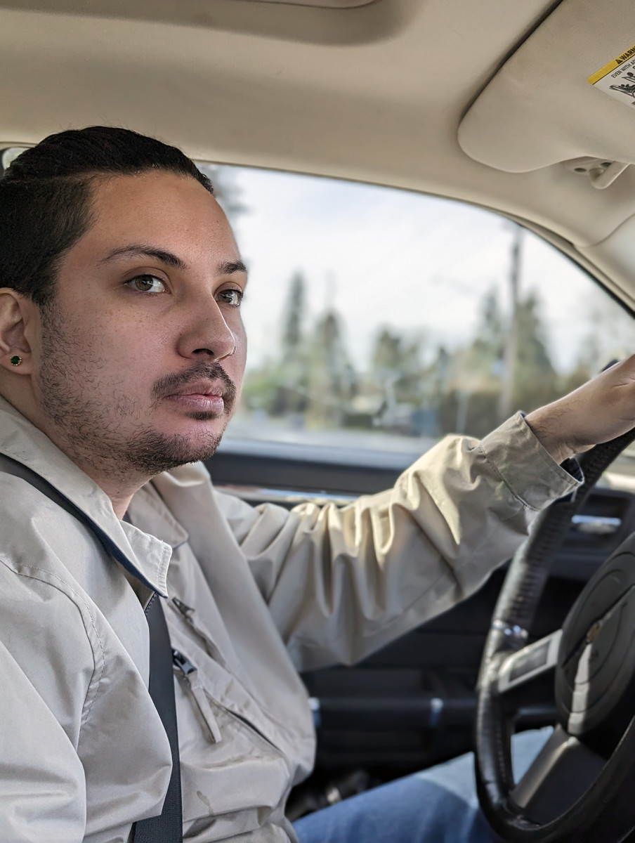 Andres “Dre” Thornock driving to Arlington, where they grew up while in foster care and a guardianship. (Nancy Marie Spears, The Imprint)