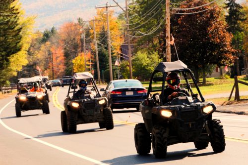 Polaris recreational off-highway vehicles riding on a highway in Gorham, N.H. (Photo by Christopher Jensen)
