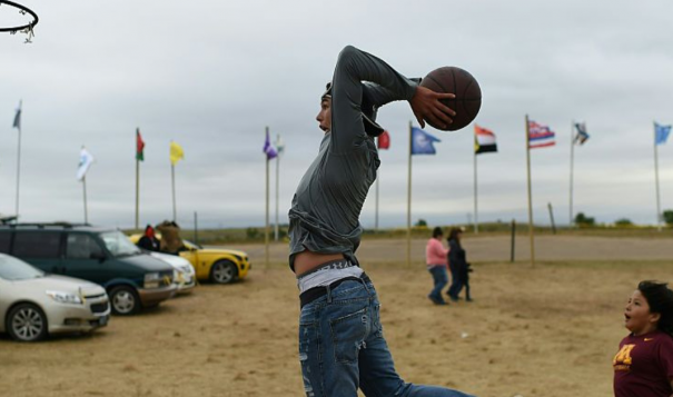 Evan Butcher of the Chippewa Tribe plays basketball near Cannon Ball, North Dakota. 2016. (Robyn Beck/AFP/Getty Images)