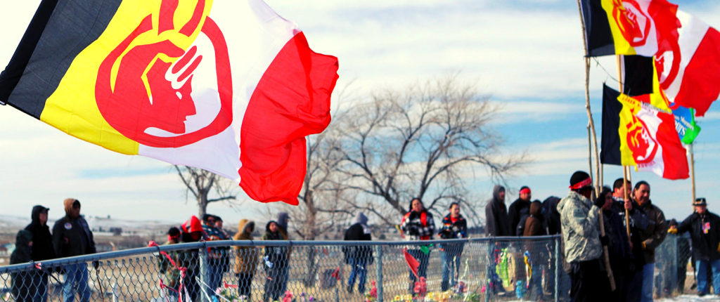 Participants in the 4 Direction Walk to Wounded Knee, South Dakota, in February 2014 native american flag