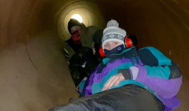 Water protectors chained themselves together inside a segment of Enbridge's Line 3, temporarily halting construction. (Photo courtesy of Ginew Collective)