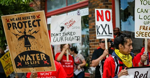In this June 12, 2019, file photo, protesters walk up Main Street inasa procession protesting against the Keystone XL pipeline makes its way to Andrew W. Bogue Federal Courthouse in Rapid City, S.D. (Adam Fondren/Rapid City Journal via AP, File)