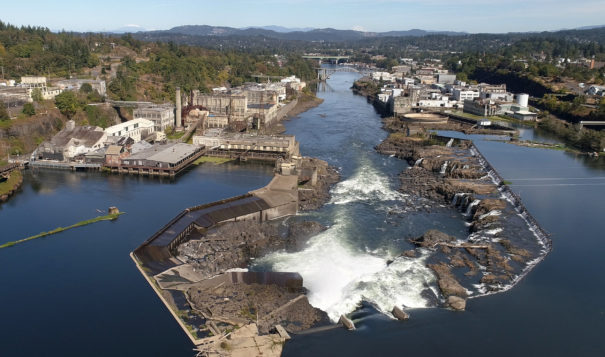 An aerial view of Willamette Falls and the former Blue Heron paper mill.  The Confederated Tribes of Grand Ronde marked the beginning of on-site work at the mill on Tues., Sept. 21, 2021.  Demolition of one of the mill's buildings was started. The tribes acquired the property in 2019 and plans on restoring the site ecologically while also creating mixed-use development and public gathering spaces.