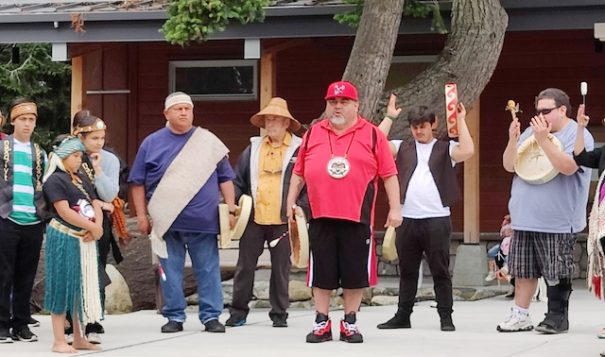 Members of the Elwha, Jamestown and Port Gamble S'Klallam tribes opened the dedication ceremony for the American Camp Visitors Center on San Juan Island in Washington State with a song on June 21, 2022. "This is who we are," said Mark Charles, in red shirt and hat at center. "We are here and we are strong." (Photo by Richard Walker for ICT)