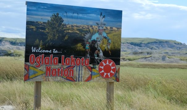 The entrance to the Oglala Lakota Nation on the Pine Ridge reservation in South Dakota sends a welcoming message to visitors, but the tribal council voted in July 2022 to ban a Christian missionary they said was demonizing Native religion and spreading hate speech. (Photo by Mary Annette Pember/ICT)