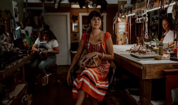 Shauna White Bear poses in her shop. She founded the company White Bear Moccasins. (Photo courtesy Chloe Nostrant)