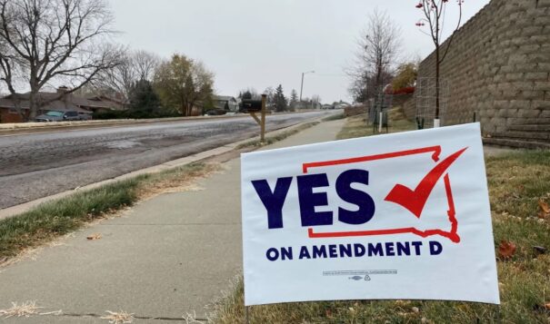 A sign in Rapid City, South Dakota, encourages people to vote in favor of Amendment D, a measure to expand Medicaid eligibility for state residents. (Arielle Zionts/KHN)