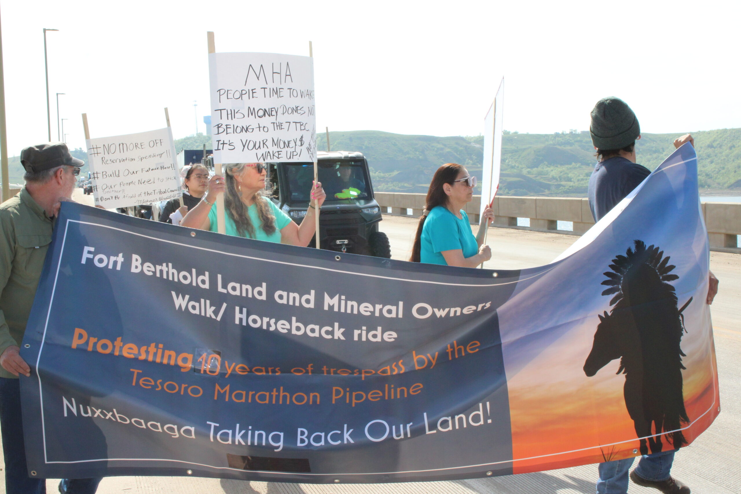 Protesters who object to Mandan, Hidatsa and Arikara Nation Tribal Business Council's lack of accountability to the people, carried a sign noting the Tesoro High Plains Pipeline trespass on individual owners allotted land near Mandaree, N.D. Photo by Jodi Rave Spotted Bear