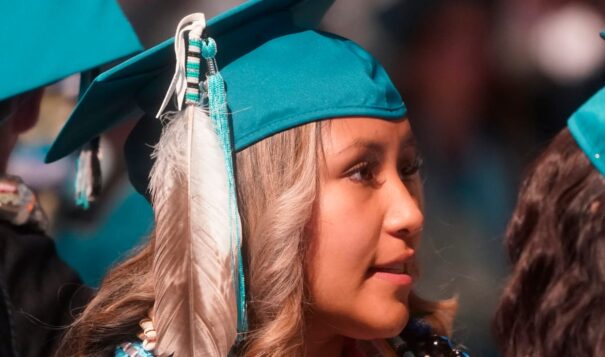 In this file photo, Brailyn Jake wears an eagle feather at her graduation from Cedar City High School in Cedar City, Utah, on May 25, 2022. Utah is among 11 states with laws that specifically protect the right of Indigenous students to wear regalia at graduation ceremonies. On May 1, 2023, Oklahoma Gov. Kevin Stitt vetoed a a bipartisan bill that would have allowed Native students across the state to wear regalia during graduation ceremonies. Tribal leaders are now calling for the Oklahoma legislature to override the veto. (AP Photo/Rick Bowmer)